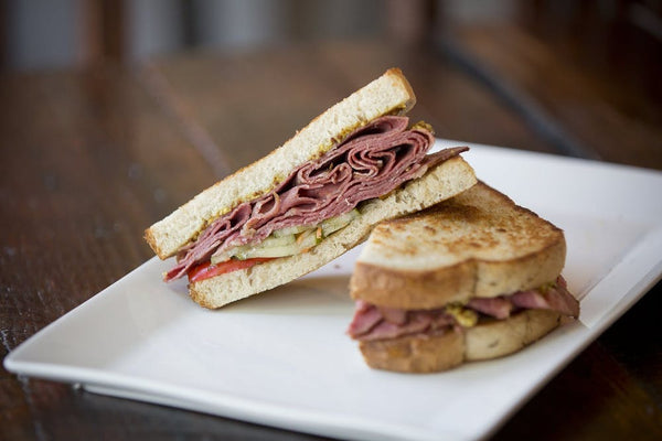 A picture of two halves of a sandwich on a plate and placed for a product photo.