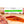 Load image into Gallery viewer, A close up of Saucisson Basque salami in packaging on a cutting board with blurred salami slices, herbs and spices in the foreground.