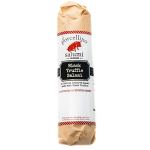 A product photo of il porcellino salumi's Black Truffle Salami in its packaging with a white background.