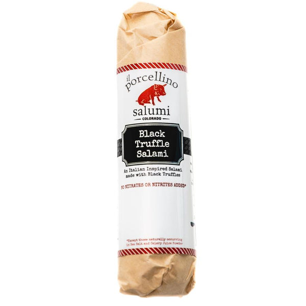 A product photo of il porcellino salumi's Black Truffle Salami in its packaging with a white background.