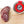 Load image into Gallery viewer, An up close picture of black truffle salami cut into slices on a cutting board next to a jar of black truffle salt.
