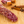 Load image into Gallery viewer, A close up of bacon whiskey salami with herbs and spices in the background.
